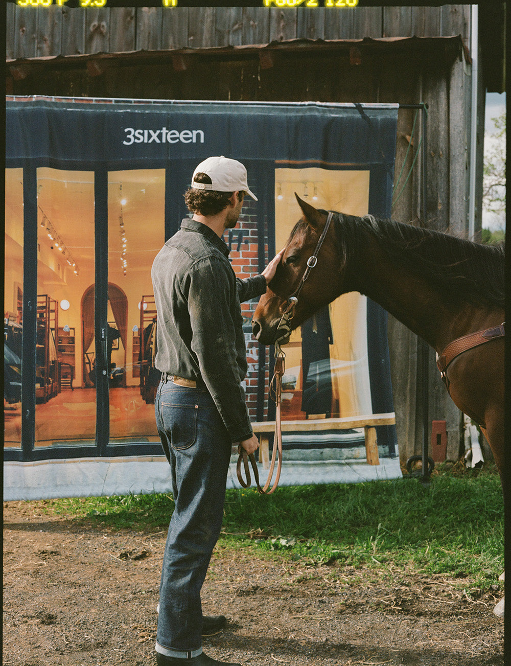 A man stands next to a horse.