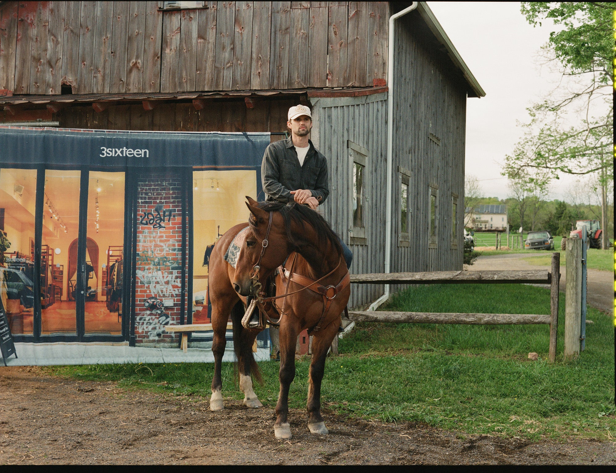 A man on a horse with a backdropo of the 3sixteen store