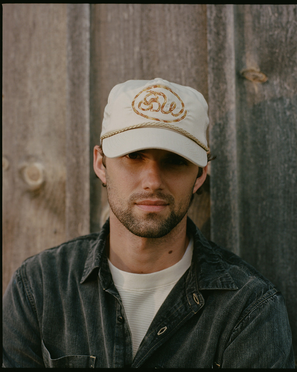 A man in a white baseball cap.