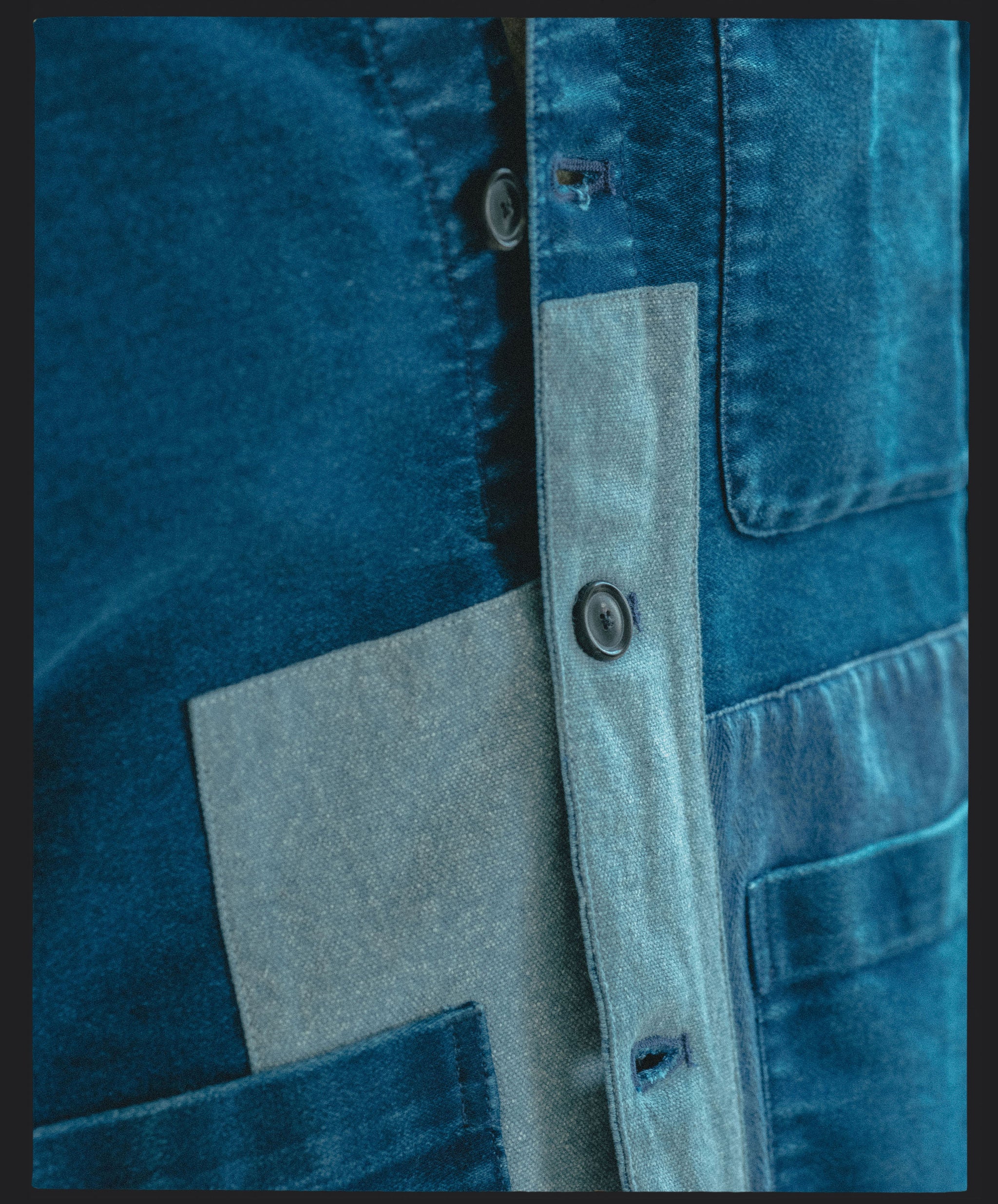 A close up image of a patchworked indigo jacket.