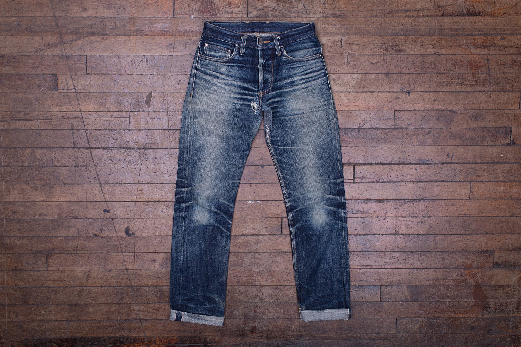 Front view of a well-aged pair of ST-100x denim by 3sixteen.
