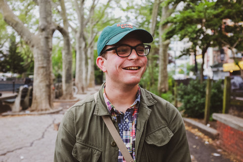 A portrait of Chris smiling and looking into the distance.