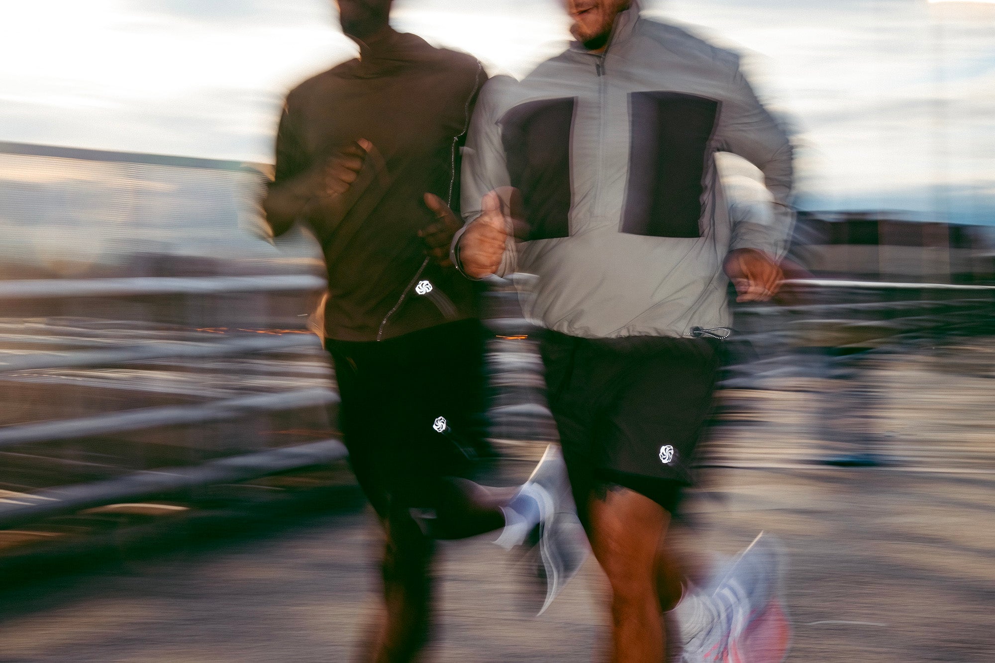 Two men run quickly with blur lines.
