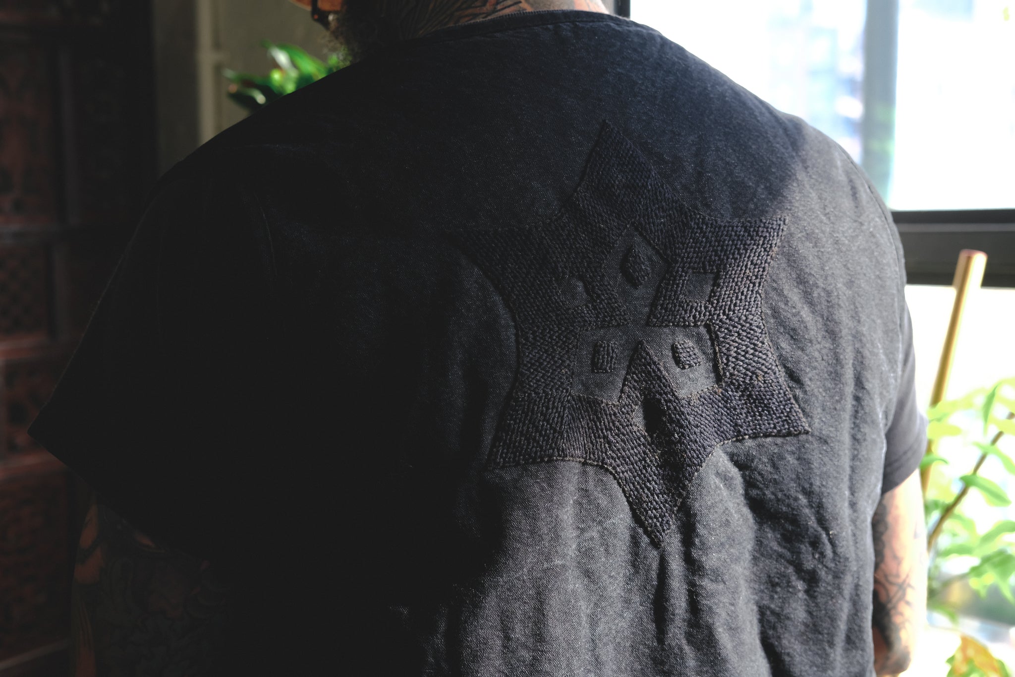 A close up image of the embroidery on the back of the vest.