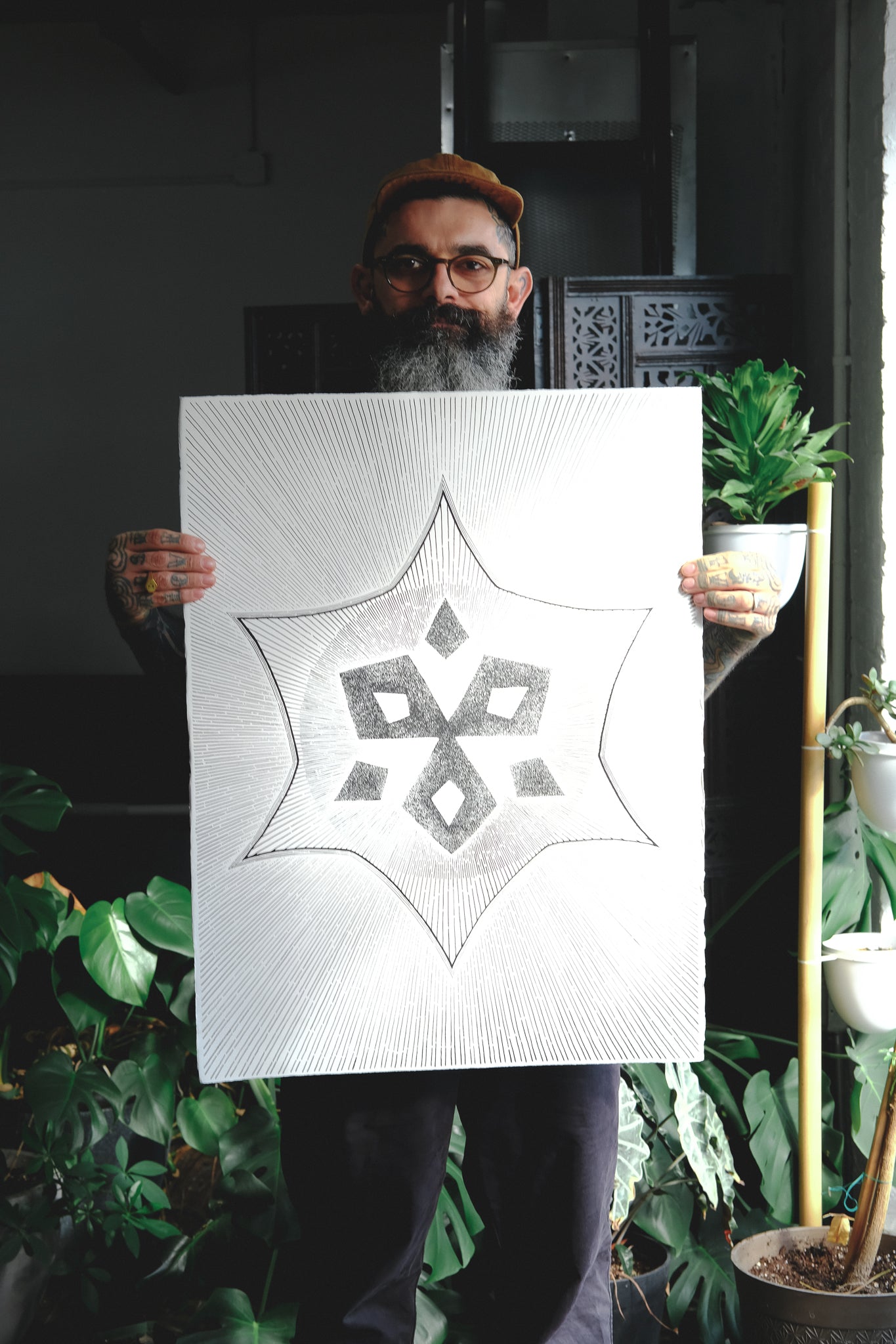 Thomas holding up a beautiful piece of art featuring the 6-point motif.