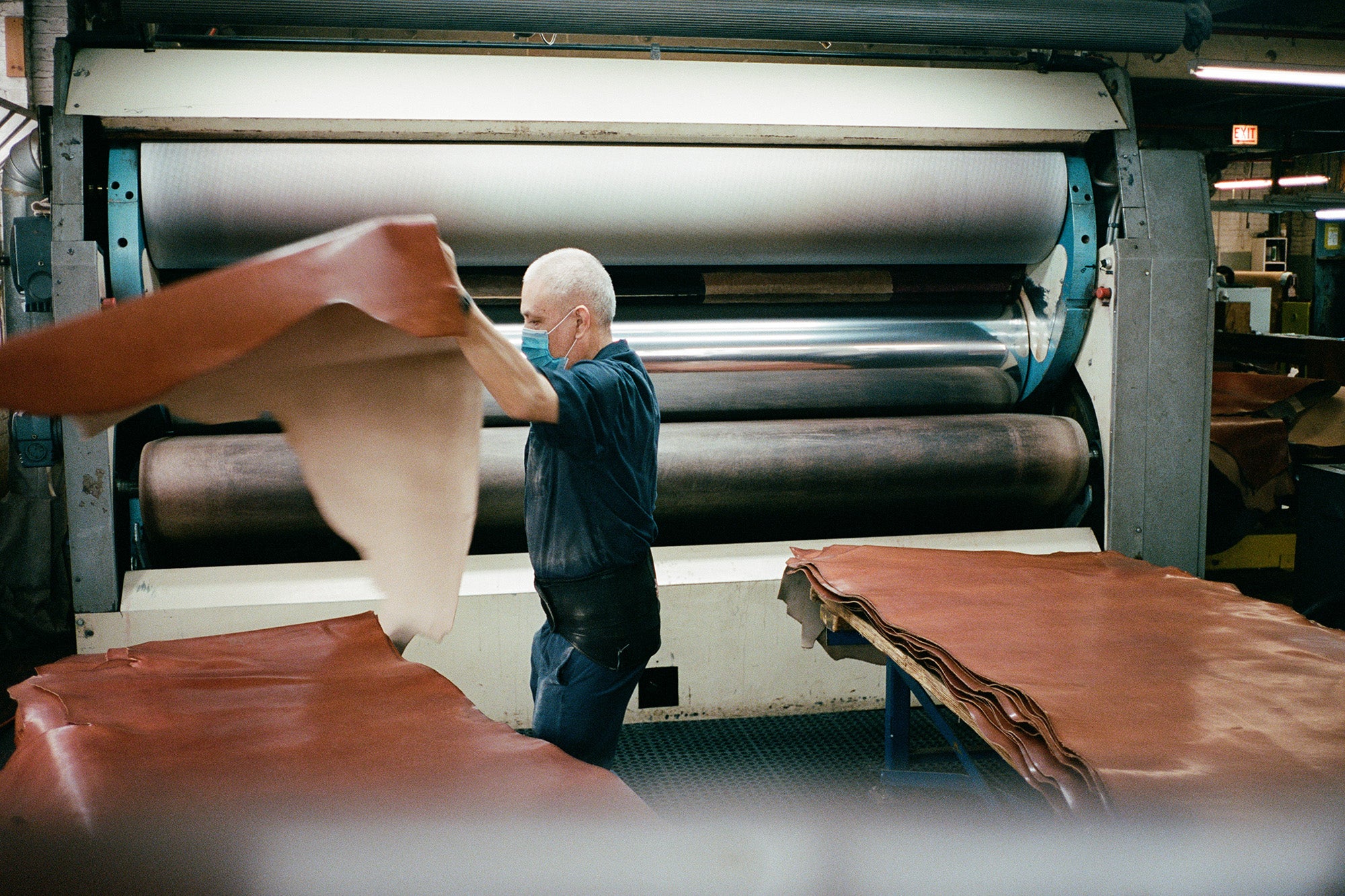 A man processes leather in a factory.