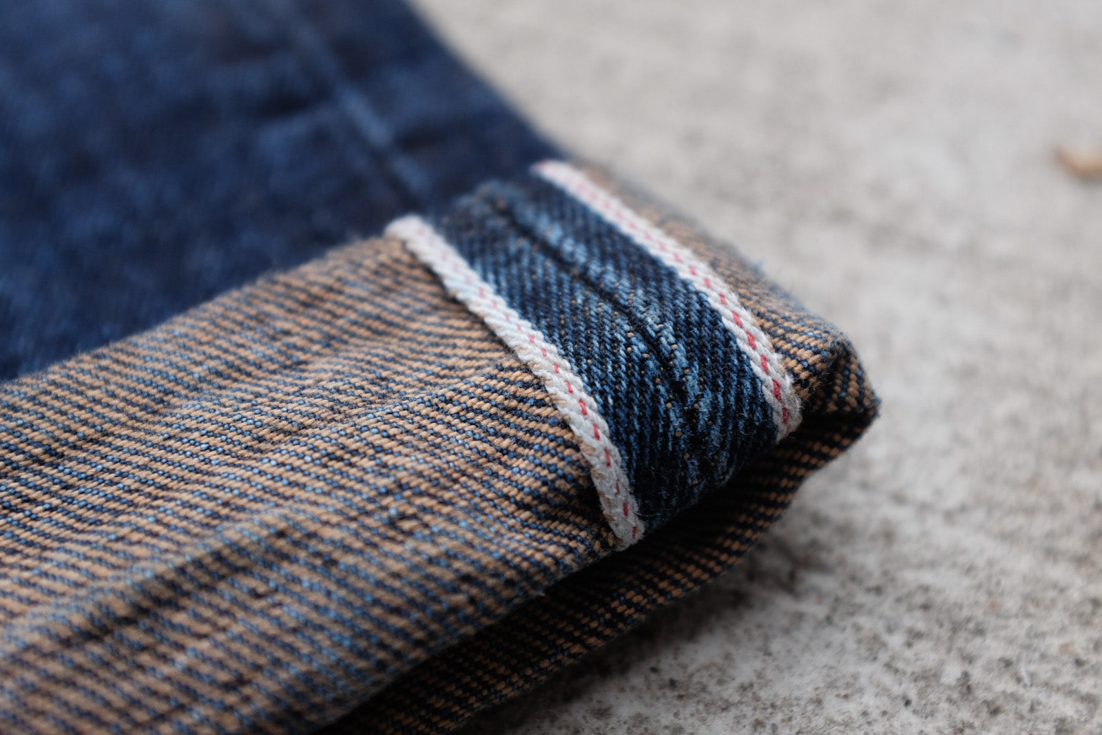 Detail shot of the upturned cuff on a pair of ST-140x showcasing the indigo and brown threads creating a pattern together.