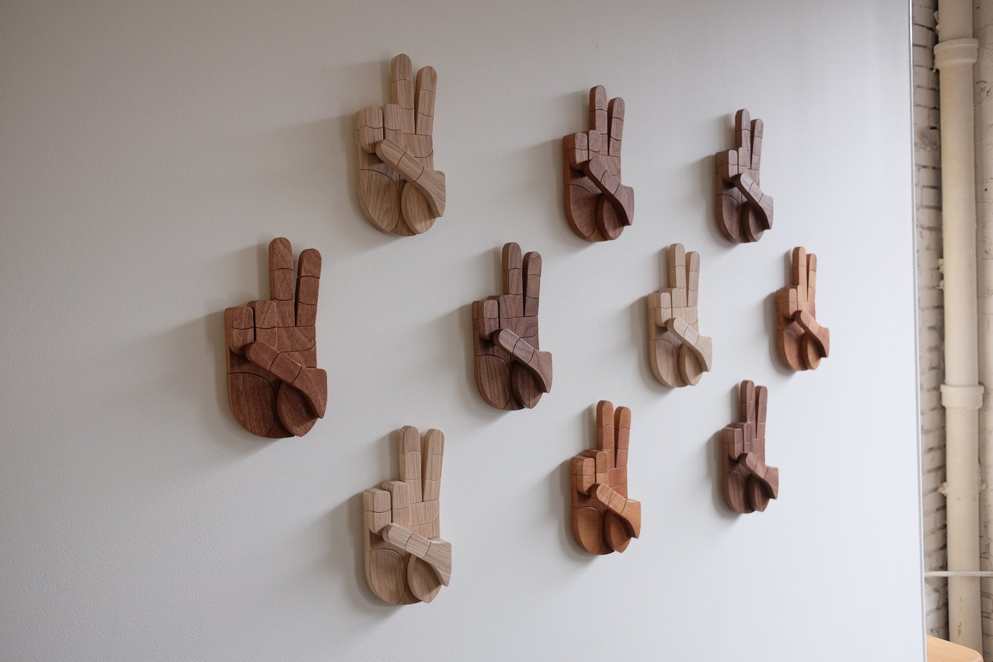 Wooden sculptures displayed on wall.