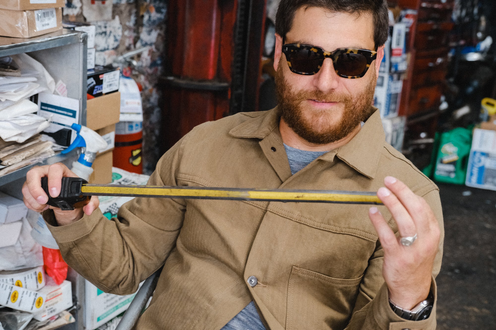 A man carefully examines a measuring tape