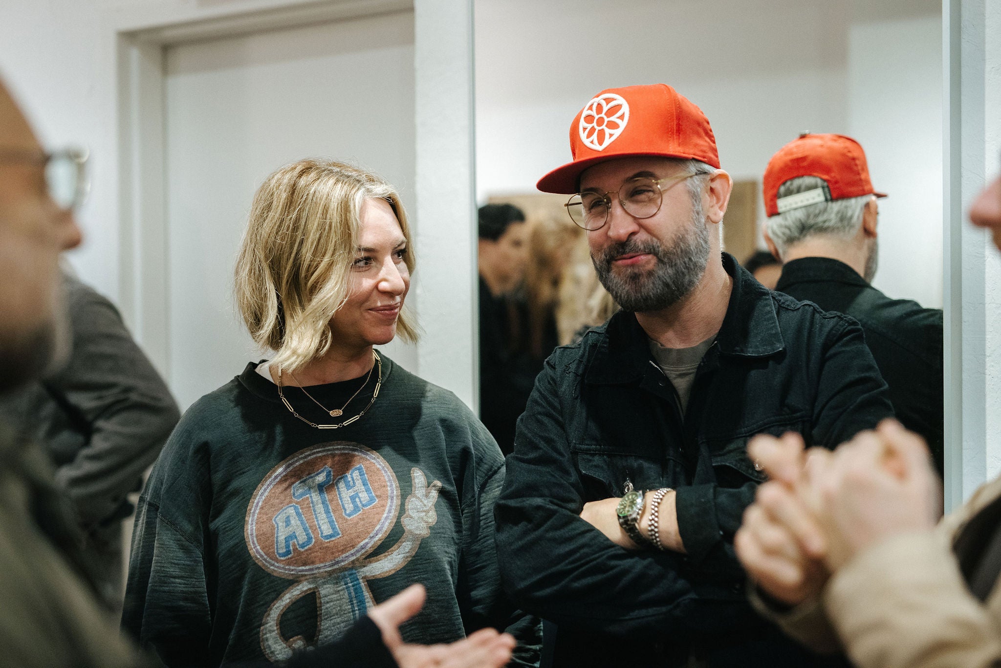 A couple talking and laughing at a party.