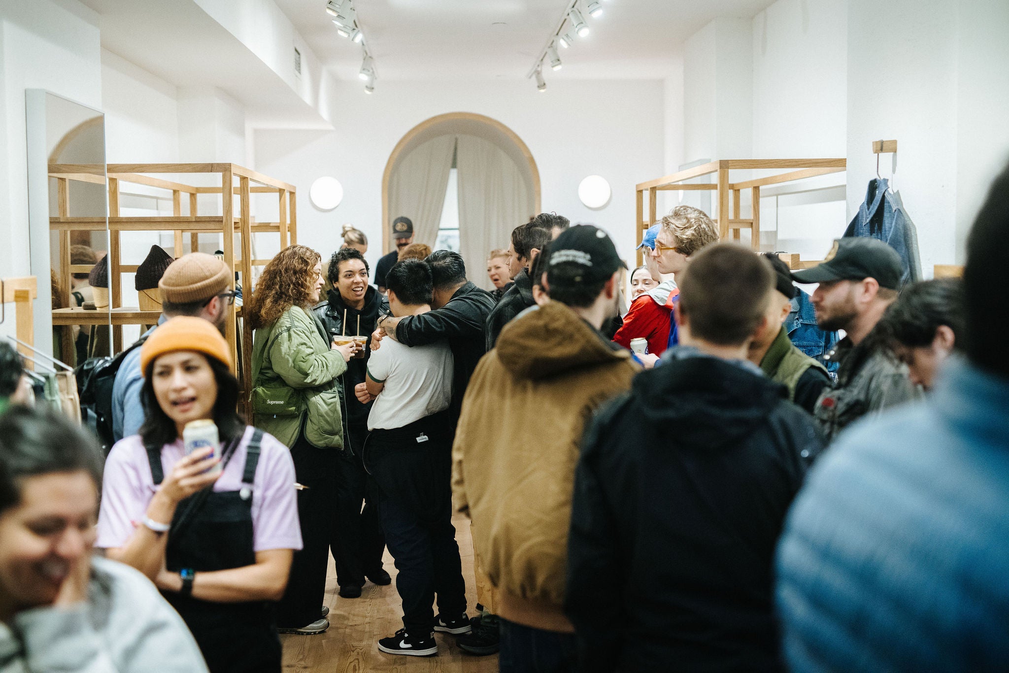 An imagee of many people gathered at a party inside the 3sixteen NY store.