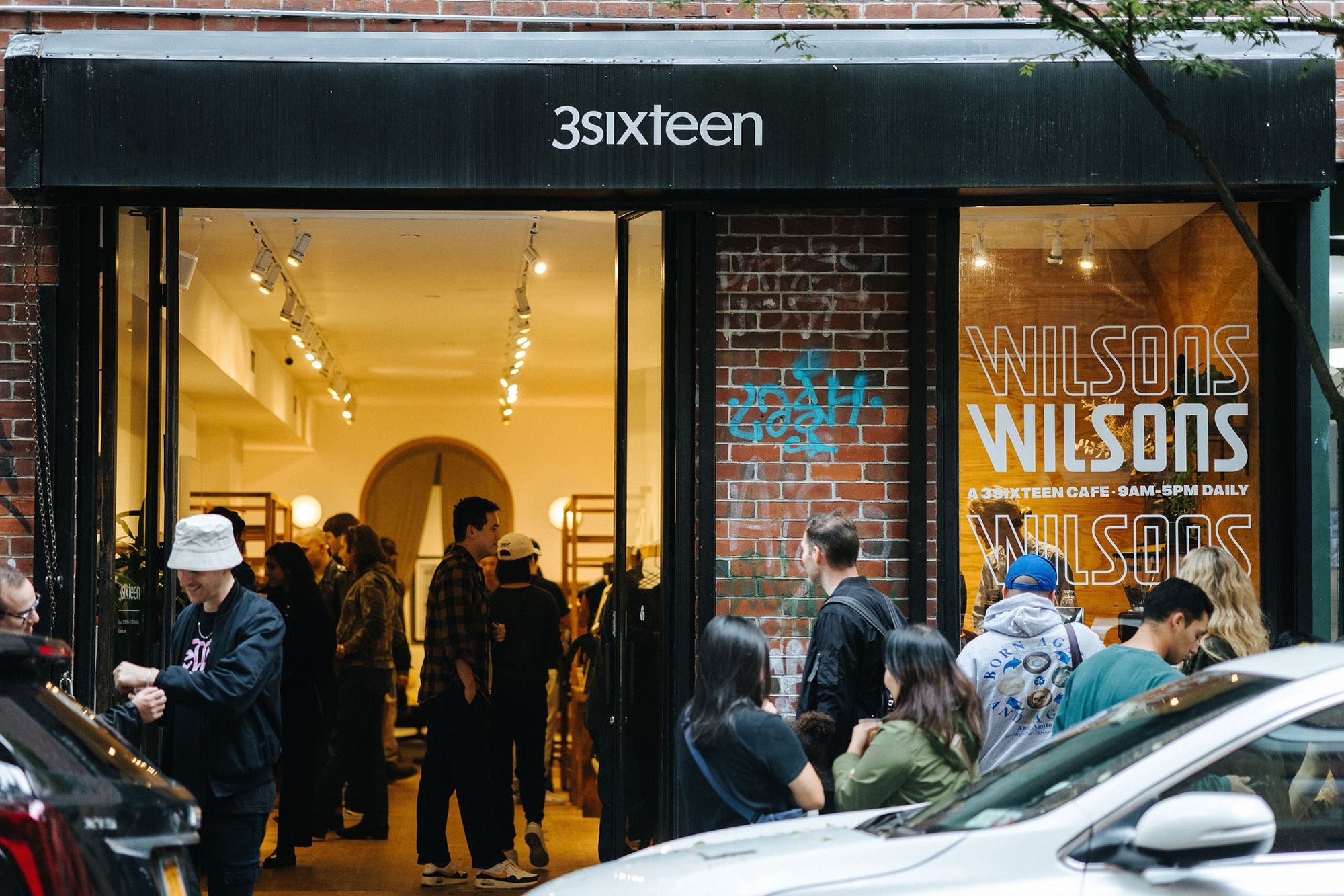A photo of the 3sixteen storefront with the doors wide open.