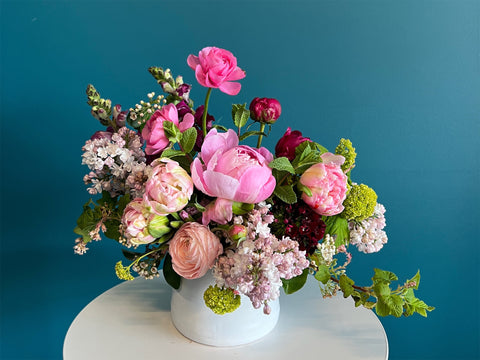A boutique floral arrangement of seasonal flowers designed in a ceramic vase. Design by Campanula Design Studio in the Magnolia neighborhood of Seattle.