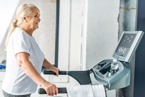 Image of an older woman exercising on a treadmill