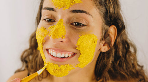 woman applying brightening face mask