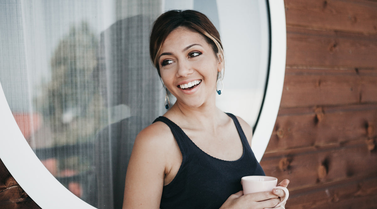 woman-smiling-holding-coffee