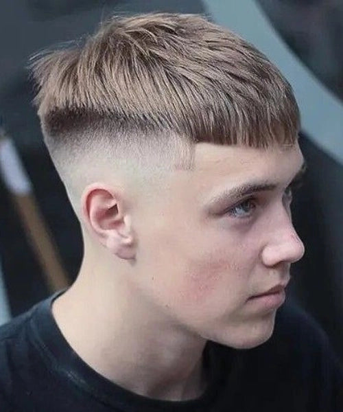 Caesar cut for straight hair with blunt fringe, tapered sides, and smooth textured top