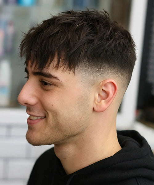 Mid Fade Messy Fringe with curls and sharp fade for a playful yet defined style.