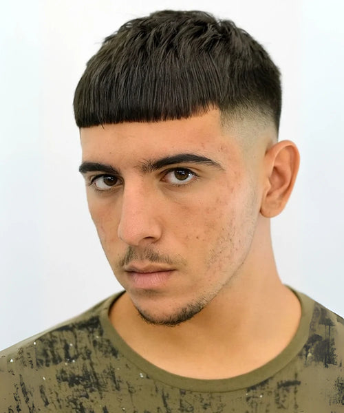 Taper fade fringe haircut with blunt front and sculpted sides