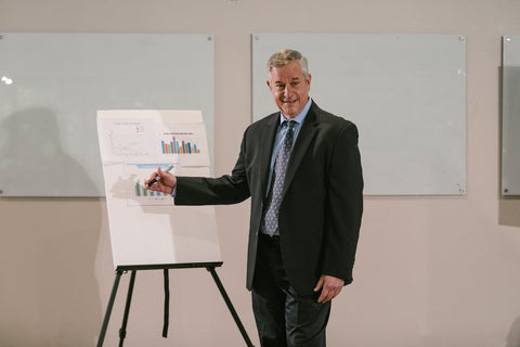 man wearing black suit blue shirt