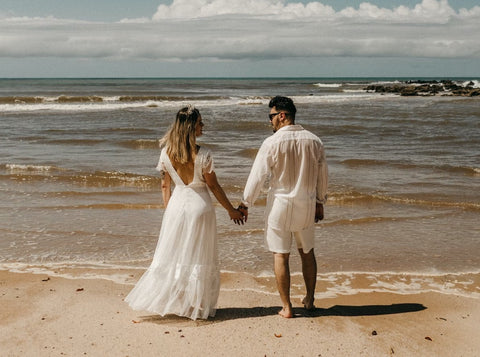 casual wedding attire for bride and groom on beach during summer