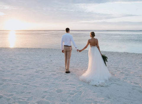 groom wearing chino pants and white shirt for beach casual wedding attire dress code