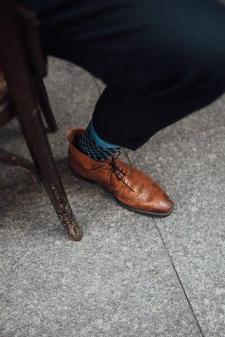 brown leather boots with dark navy pants