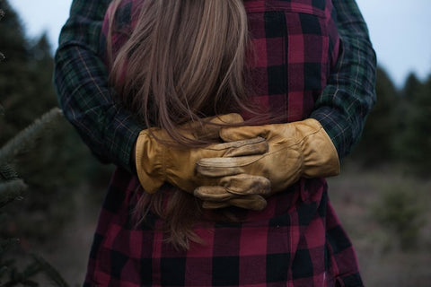 Couple embracing wearing flannel.