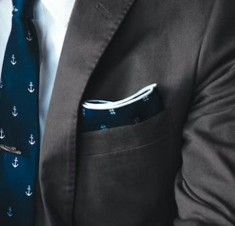 dark gray suit jacket with blue pocket square and blue tie