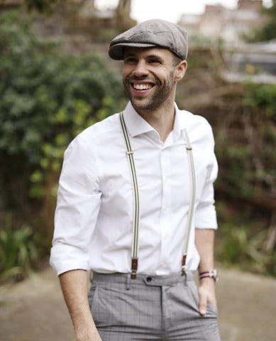 gray and white outfit example with subtle patterned suspenders and baret