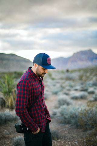 Man wearing red flannel outdoors.