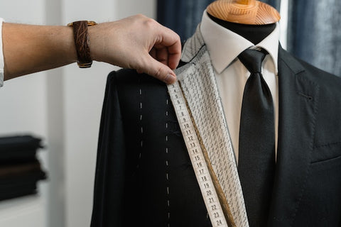 custom suit on mannequin with measuring tape