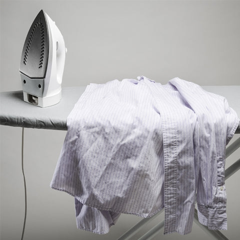 Iron and ironing board with mens dress shirt
