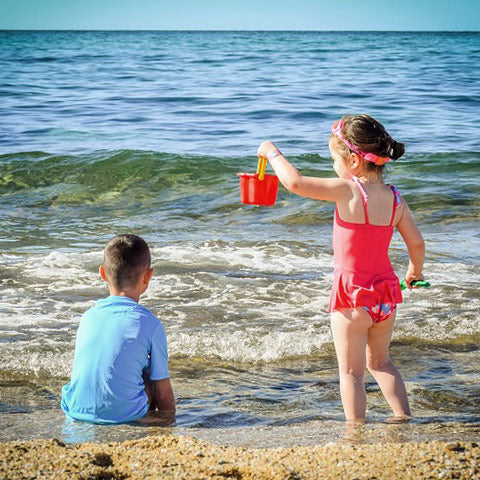 kids play on beach in swimwear