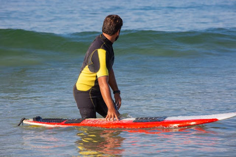 man in wetsuit waiting for a wave