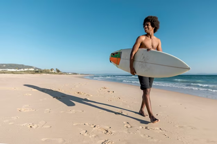 a man with a surfboard on a beach
