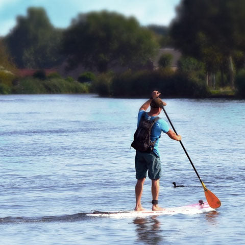 man on sup paddle board