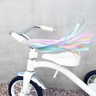 pink bike with basket and tassels