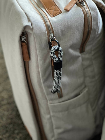 backpack with a lizard tail keychain to help identify it 