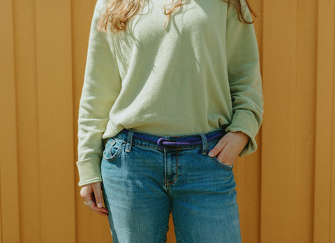 woman wearing Lizard Tail rope belt with jeans and a long sleeve shirt