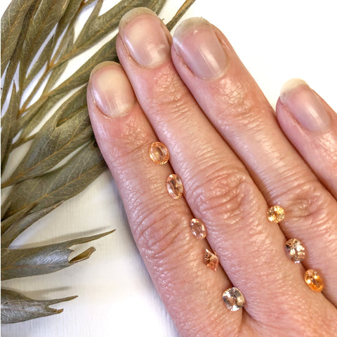 Peachy pink sapphires faceted on hand