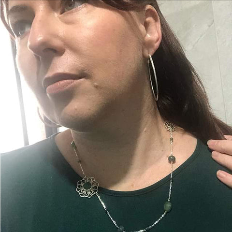 Lady wearing silver greenstone mandala necklace