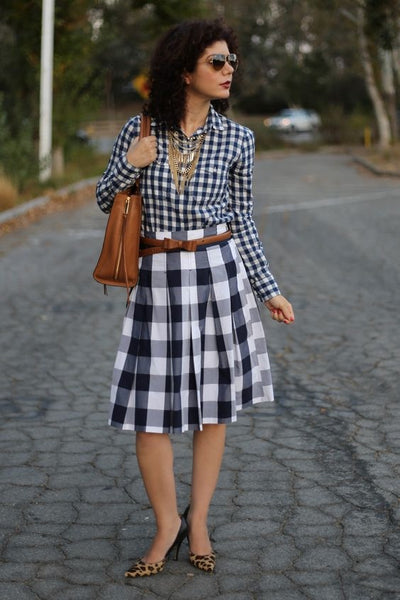 woman bolder gingham print with smaller print leopard print shoes brown belt brown bag