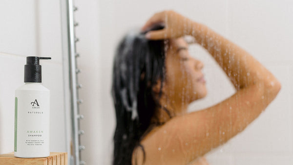 Young woman using Awaken Shampoo