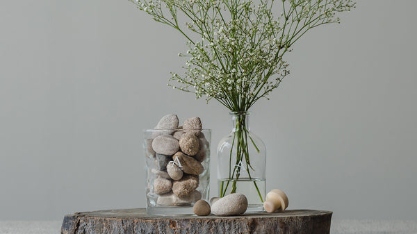 Recycling old candle jars as decor with flowers