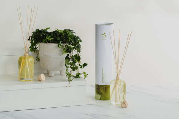 Image shows 2 reed diffusers and the cylinder packaging they come in 