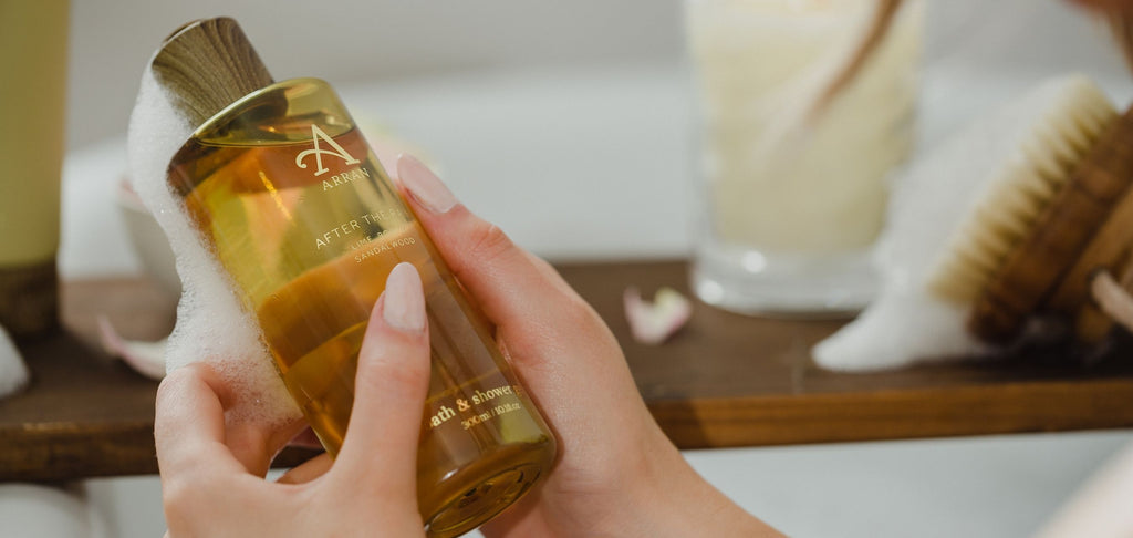 Image of woman holding an After the Rain Shower Gel in bath 