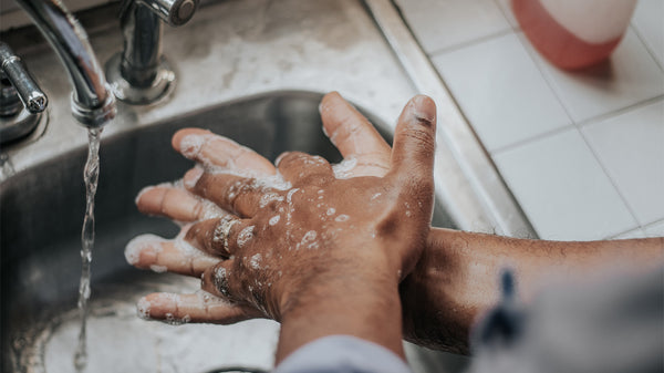 Hand washing over kitchen sink 