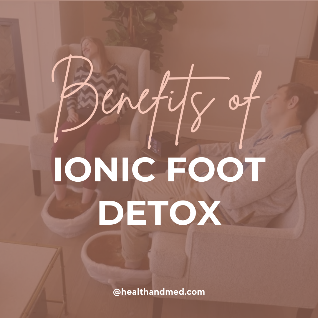 a couple sitting in chairs taking ionic foot detox baths overlayed with a coral color and text reading Benefits of Ionic Foot Detox