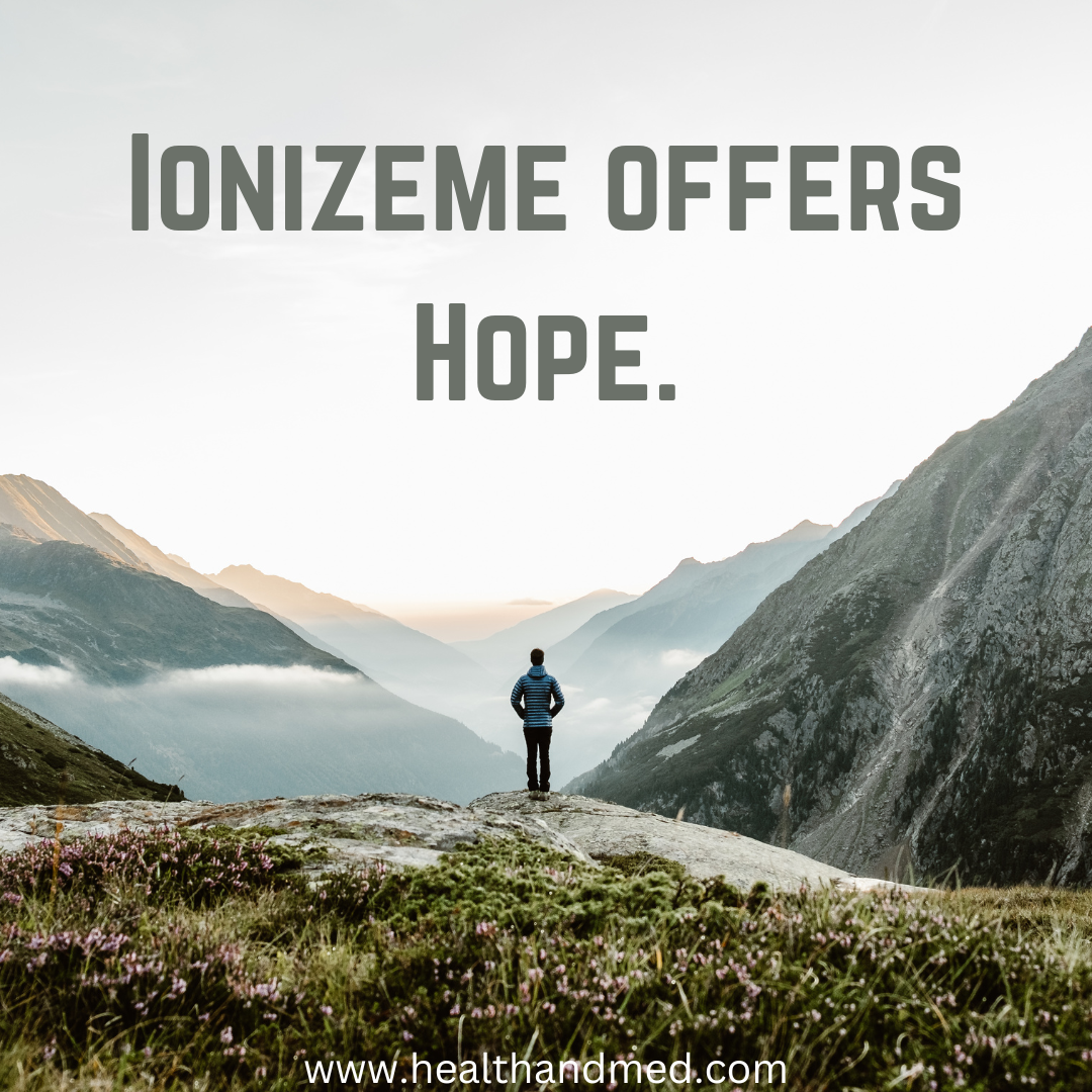 A person standing on a hill in the middle of mountains facing away.  Text reads IonizeMe Offers Hope.